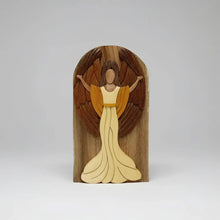 A hand-carved wooden joyful angel with light and dark tones featuring a secret compartment for gift cards