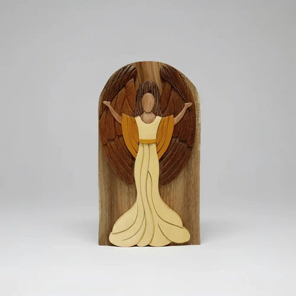 A hand-carved wooden joyful angel with light and dark tones featuring a secret compartment for gift cards