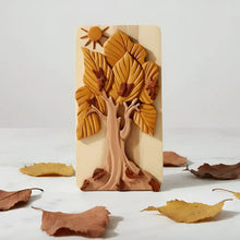 Hand-carved wooden tree box phone stand with detailed autumn tree golden leaves birds and sun motif at top