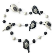 A charming black and white felted wool bird garland with embroidered details perfect as a white bird garland decor