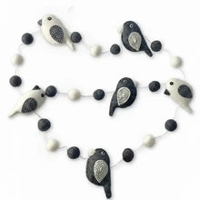 A charming black and white felted wool bird garland with embroidered details perfect as a white bird garland decor