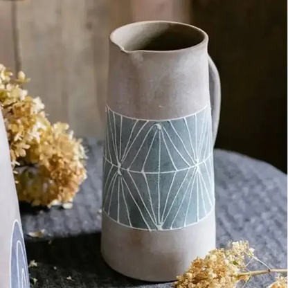 Tall gray ceramic table pitcher with light blue hand-painted terracotta geometric pattern