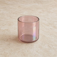 A handblown cocktail glass in translucent rose gold with an iridescent sheen and a lustrous finish that catches light