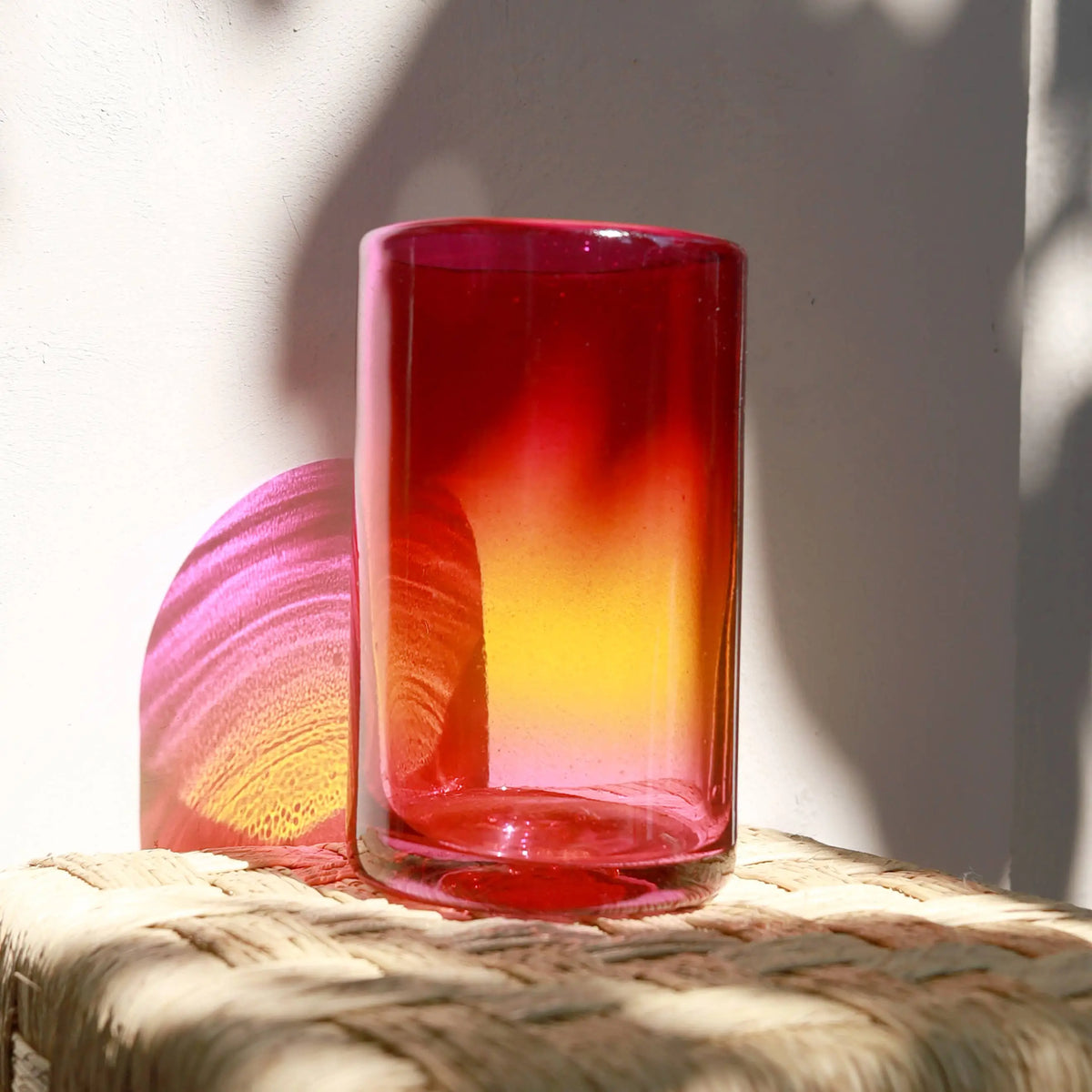 Hand blown Arco glass tumbler in red-to-orange gradient, 8 inches tall