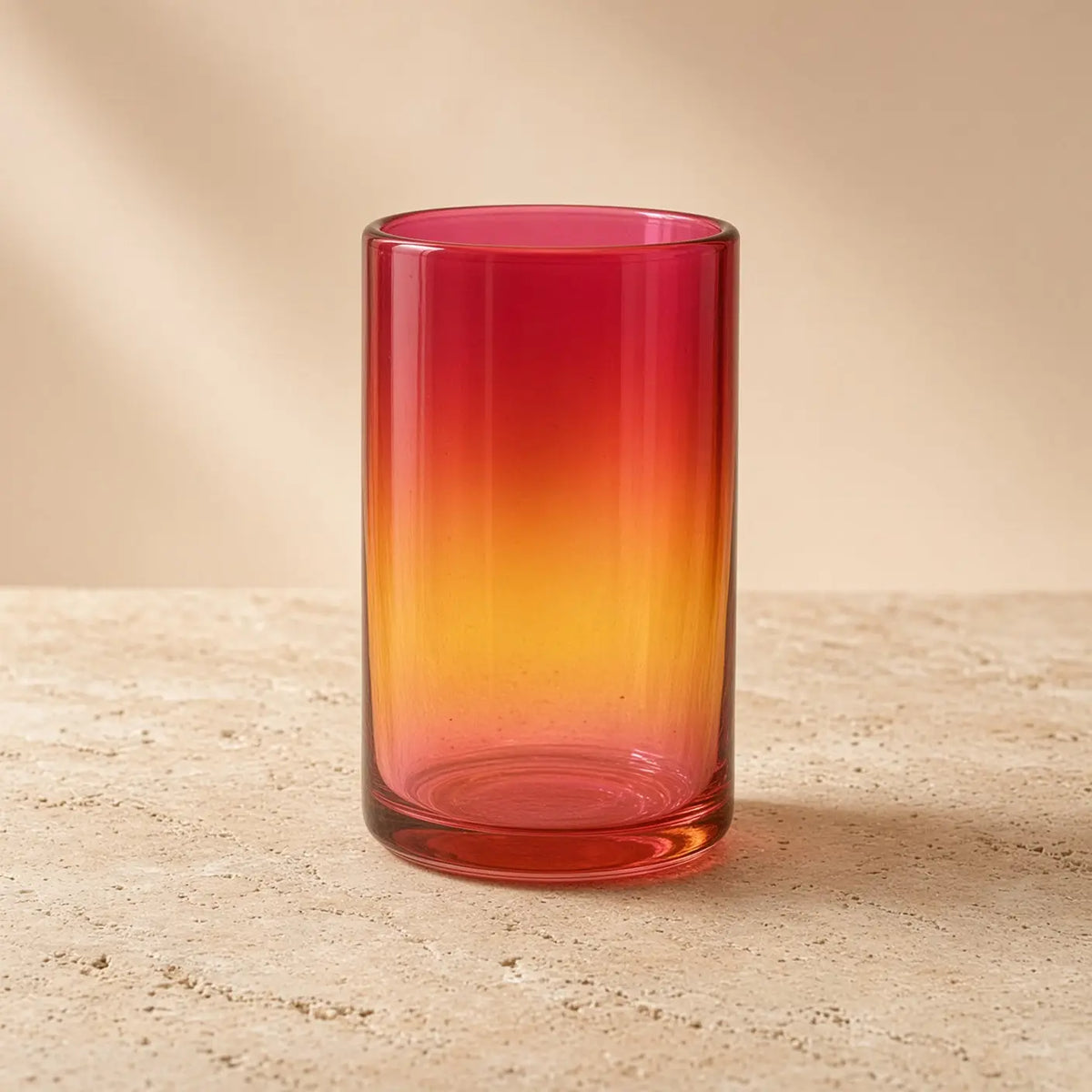 Handblown glass tumbler with red pink orange gradient brings artisan warmth from family workshop nestled design