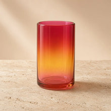 Handblown glass tumbler with red pink orange gradient brings artisan warmth from family workshop nestled design