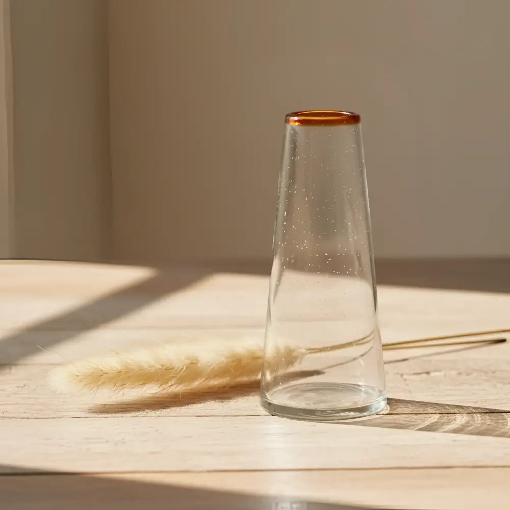 Handblown recycled glass conical vase with amber rim on rustic wood