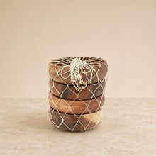Stack of four handmade round individual acacia wood serving bowls with natural grain and warm brown tones wrapped in netting