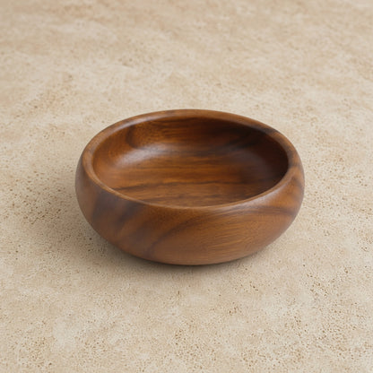 Handcrafted acacia wood round salad bowl with a smooth rich brown finish and visible natural wood grain