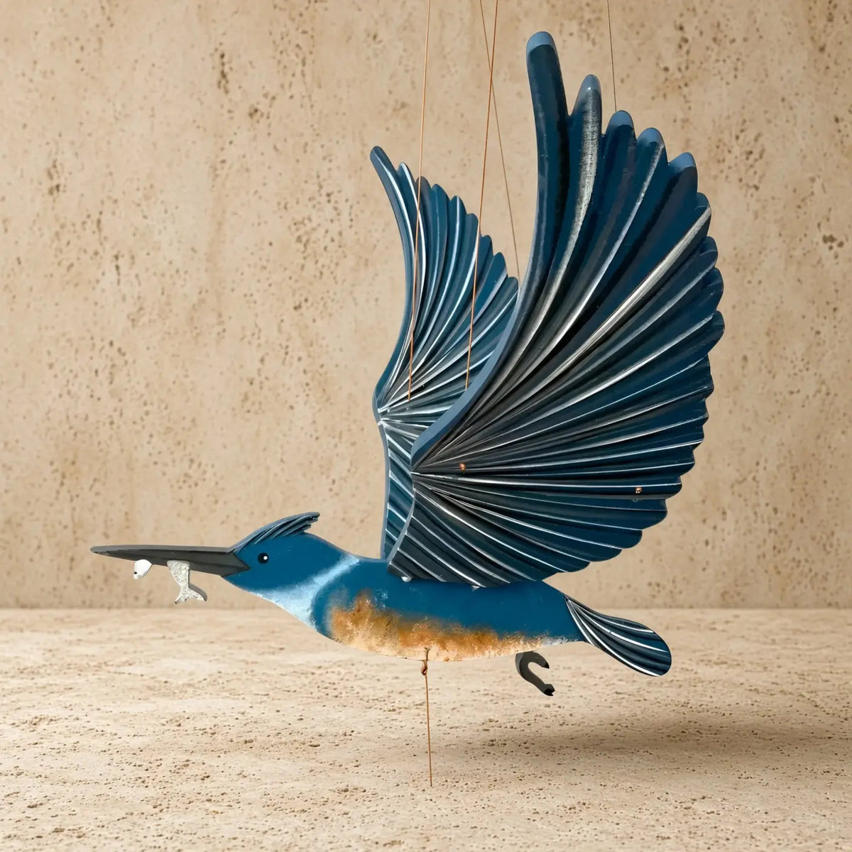 A handcrafted belted kingfisher flying bird kinetic mobile with detailed blue and orange painted wood wings perfectly balanced