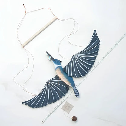 Handcrafted blue and white wooden belted kingfisher flying bird mobile with fan-like wings for indoor decor