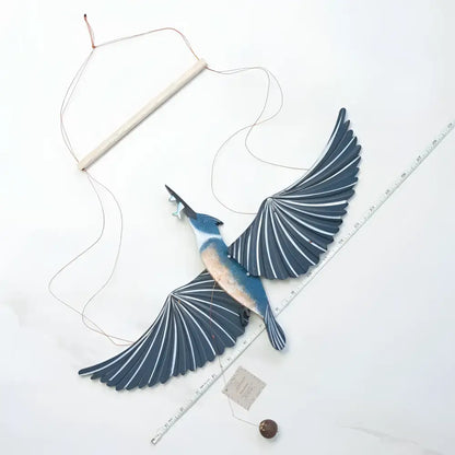 Handcrafted blue and white wooden belted kingfisher flying bird mobile with fan-like wings for indoor decor