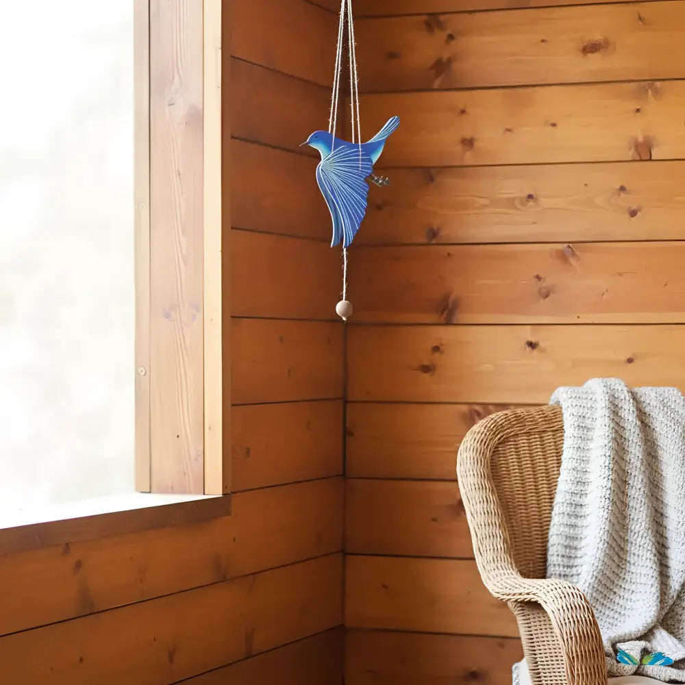 Handcrafted blue bird flying mobile with a textured layered design and small wooden bead for happiness creates ethical décor