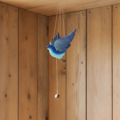 Handcrafted blue bird flying mobile with detailed wing feathers and a hanging wooden bead for happiness creates ethical decor