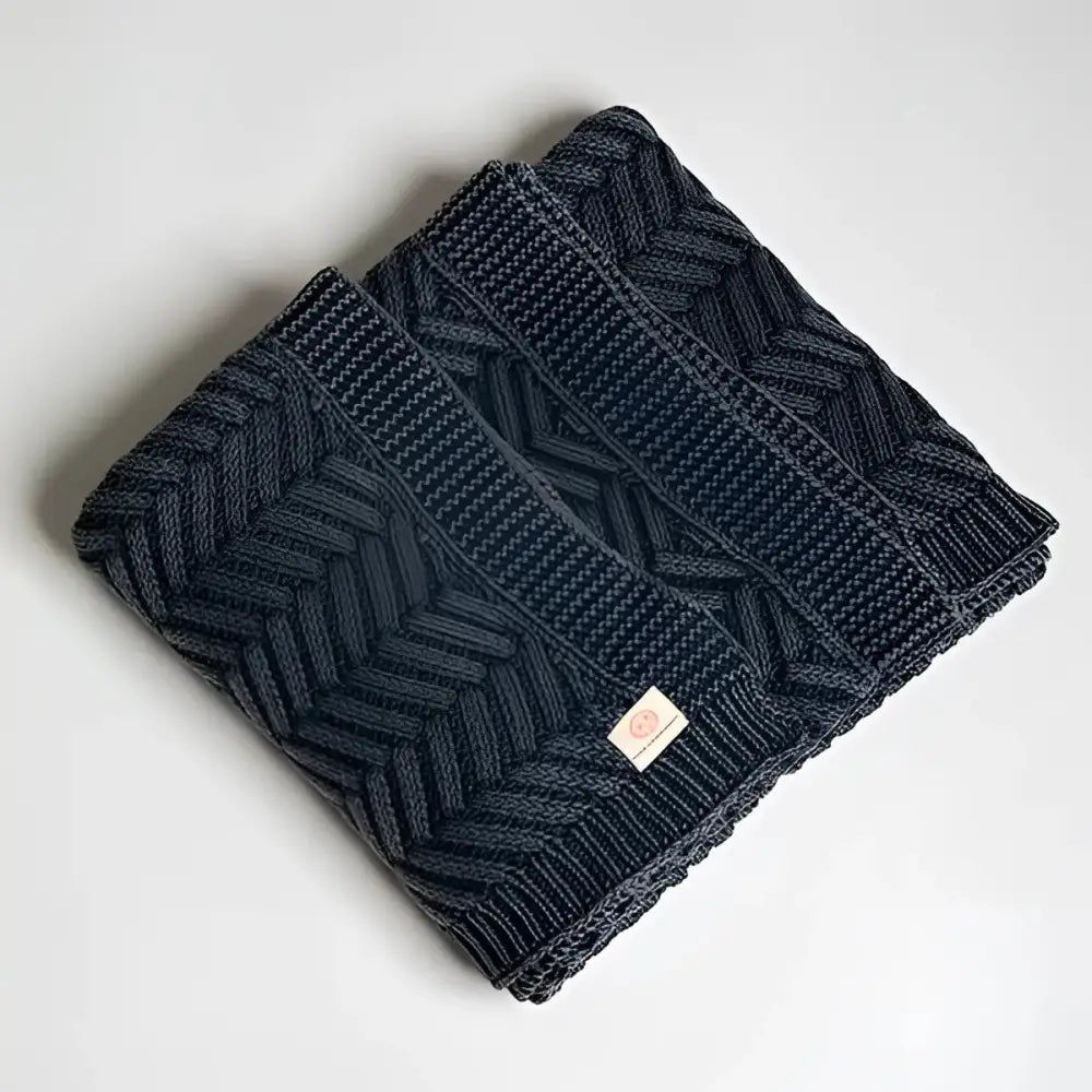 Handcrafted dark blue cable knit shawl with herringbone chevron pattern