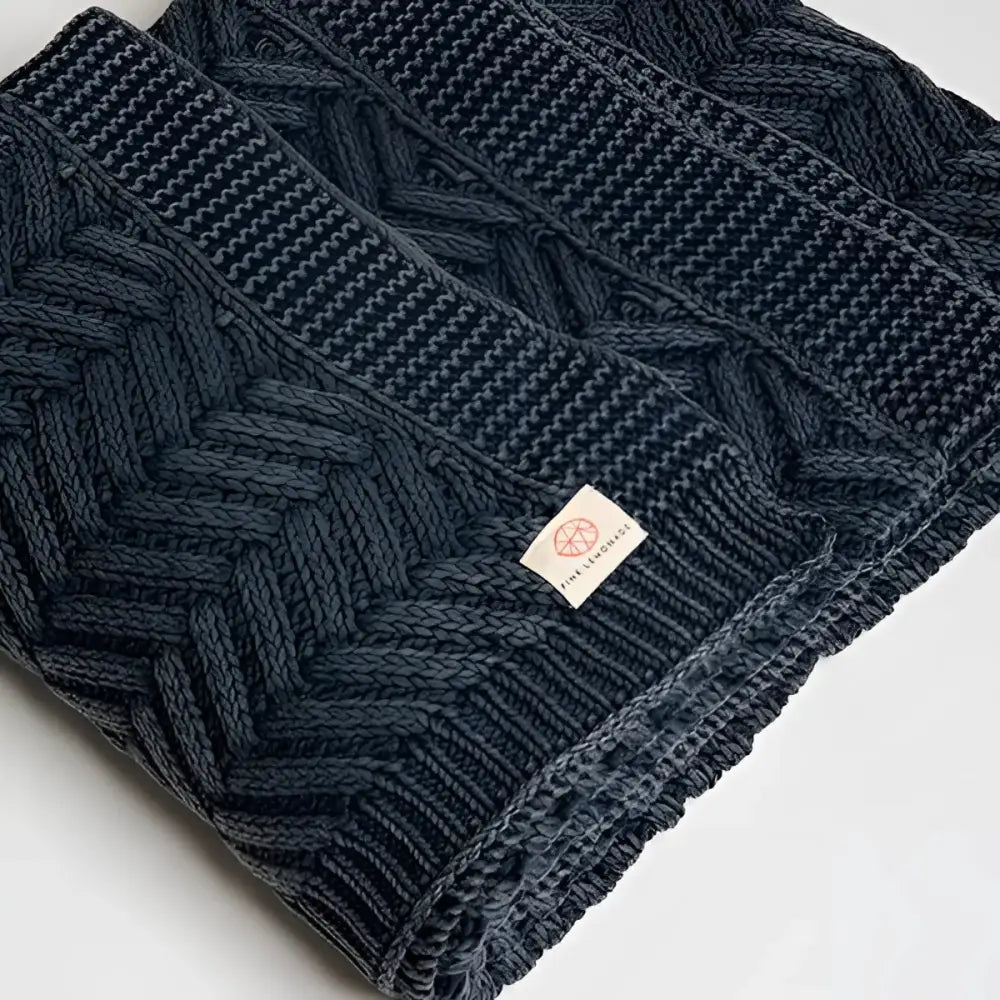 Handcrafted dark blue cable knit shawl with textured chevron pattern