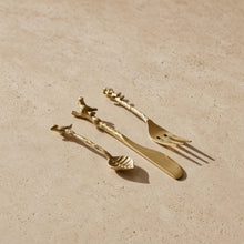 Gold-toned three-piece brass serving dessert set with intricately designed branch handles and birds for an artful experience