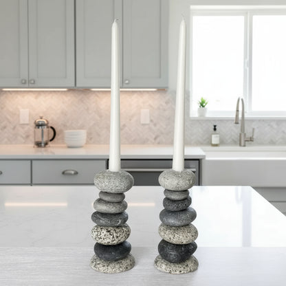 Handcrafted eco-friendly stone candle holder with white candles and natural gray and black stones
