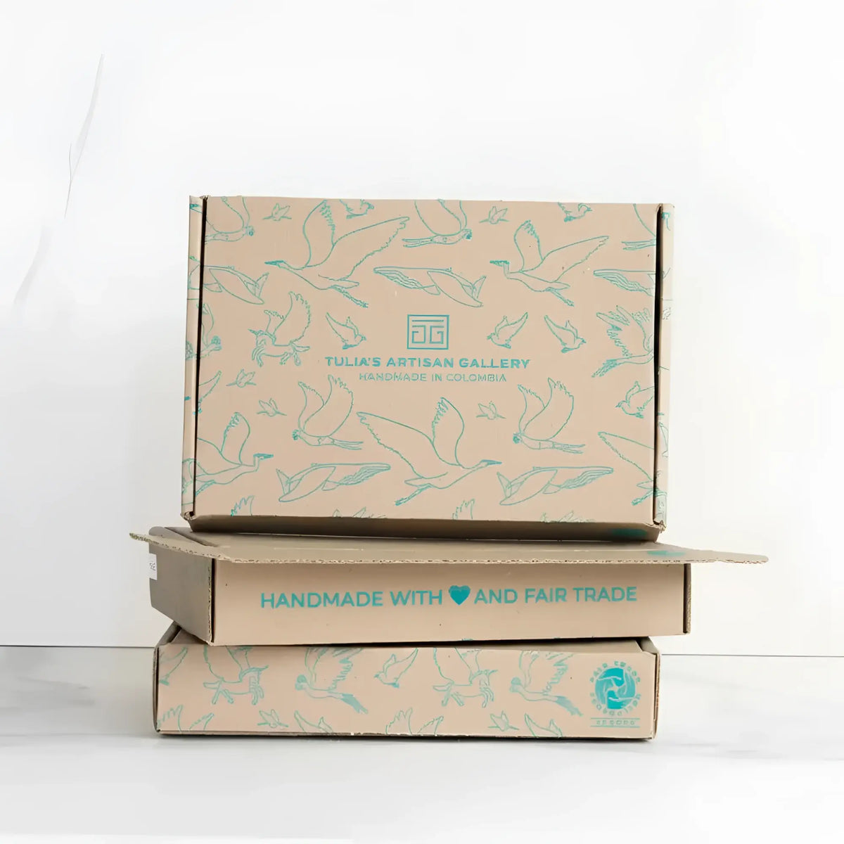 Stack of three beige cardboard boxes with light blue bird illustrations for a perfectly balanced playful flutter cardinal mobile