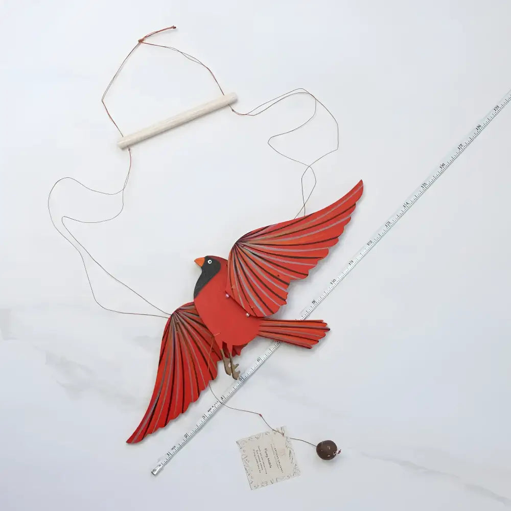 Handcrafted red cardinal mobile with layered wings and wooden hanging bar perfectly balanced for playful flutter