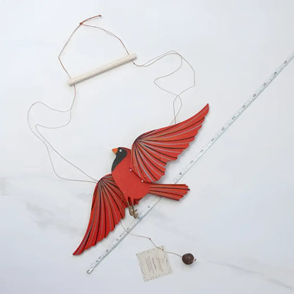 Handcrafted red cardinal mobile with layered wings and wooden hanging bar perfectly balanced for playful flutter