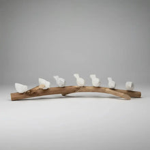 Handcrafted eco-friendly ceramic bird figurines on wooden branch for home decor