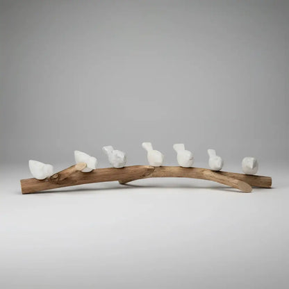 Handcrafted eco-friendly ceramic bird figurines on wooden branch for home decor