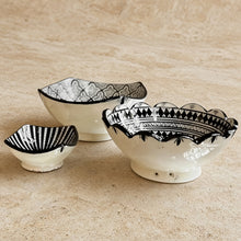 Three handcrafted ceramic bowls from safi morocco with black geometric patterns and scalloped edges in white ceramic