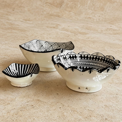 Three handcrafted ceramic bowls from safi morocco with black geometric patterns and scalloped edges in white ceramic