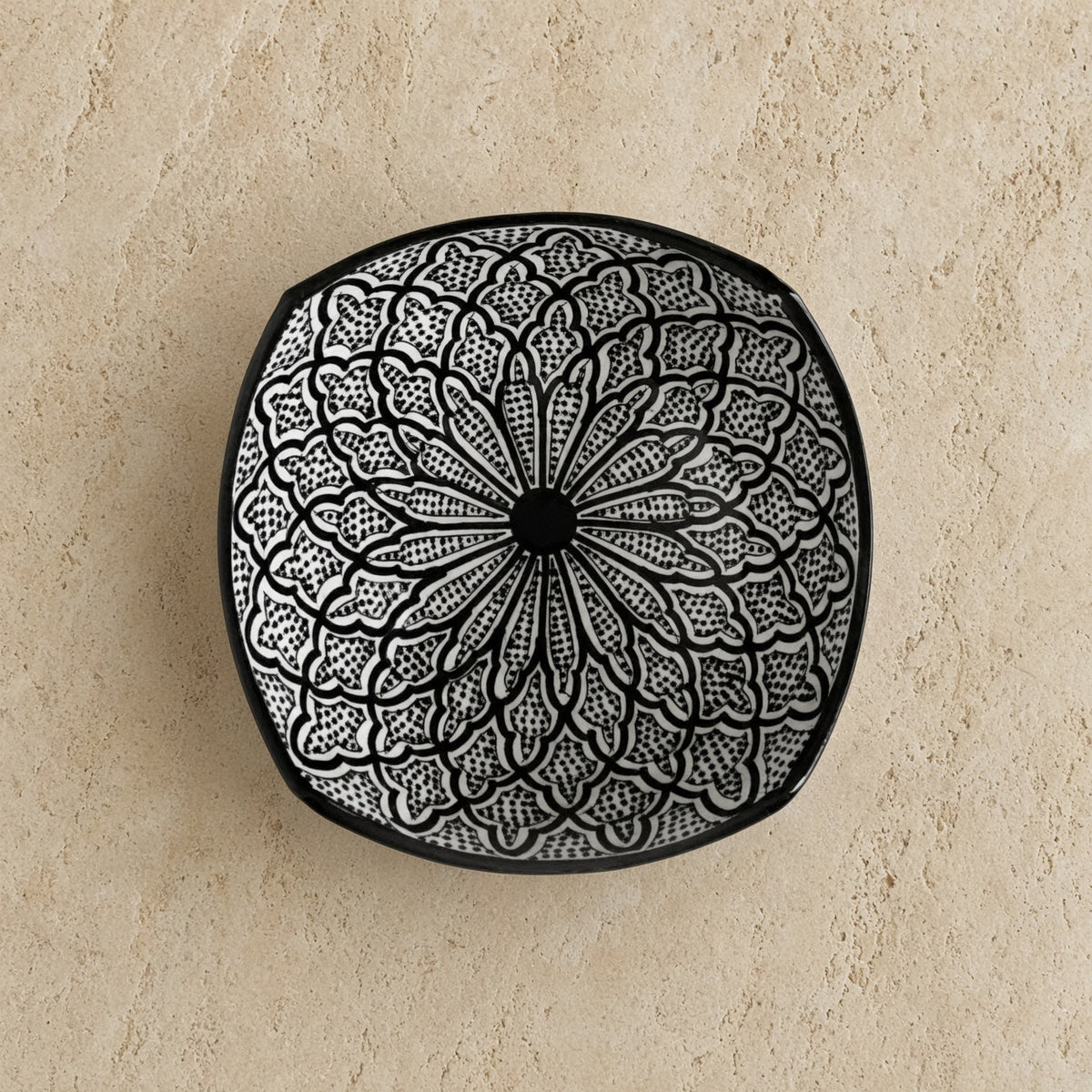Black and white handcrafted ceramic bowl with intricate floral pattern from safi morocco inspired by rugged atlantic designs