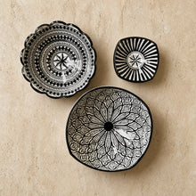 Three black and white handcrafted ceramic bowls from safi morocco with intricate geometric and floral black patterns
