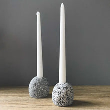 Handmade eco-friendly ceramic candleholder with white taper candle and speckled gray stone base