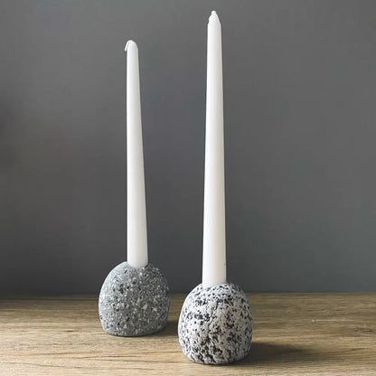 Handmade eco-friendly ceramic candleholder with white taper candle and speckled gray stone base