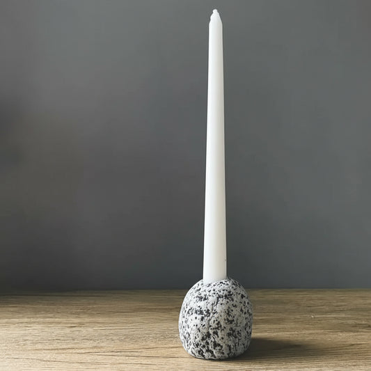 Handmade eco-friendly ceramic candleholder with white taper candle and speckled gray stone base