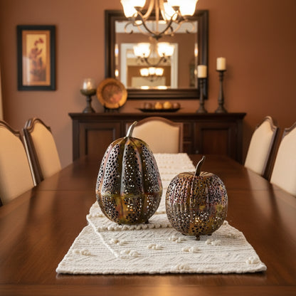 Handmade eco-friendly metallic pumpkin lanterns with intricate cut-out designs in gold and silver tones