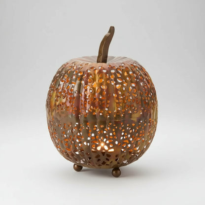Copper-colored handmade eco-friendly metal pumpkin lantern with intricate perforations and flame