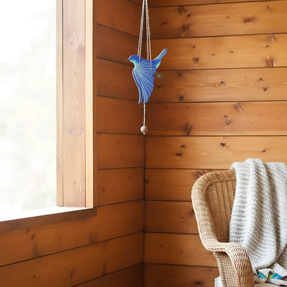 Handcrafted blue bird flying mobile with a textured layered design and small wooden bead for happiness creates ethical décor