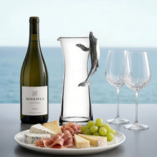 Clear glass carafe with a pewter whale handle adding a nautical twist to your drinkware collection