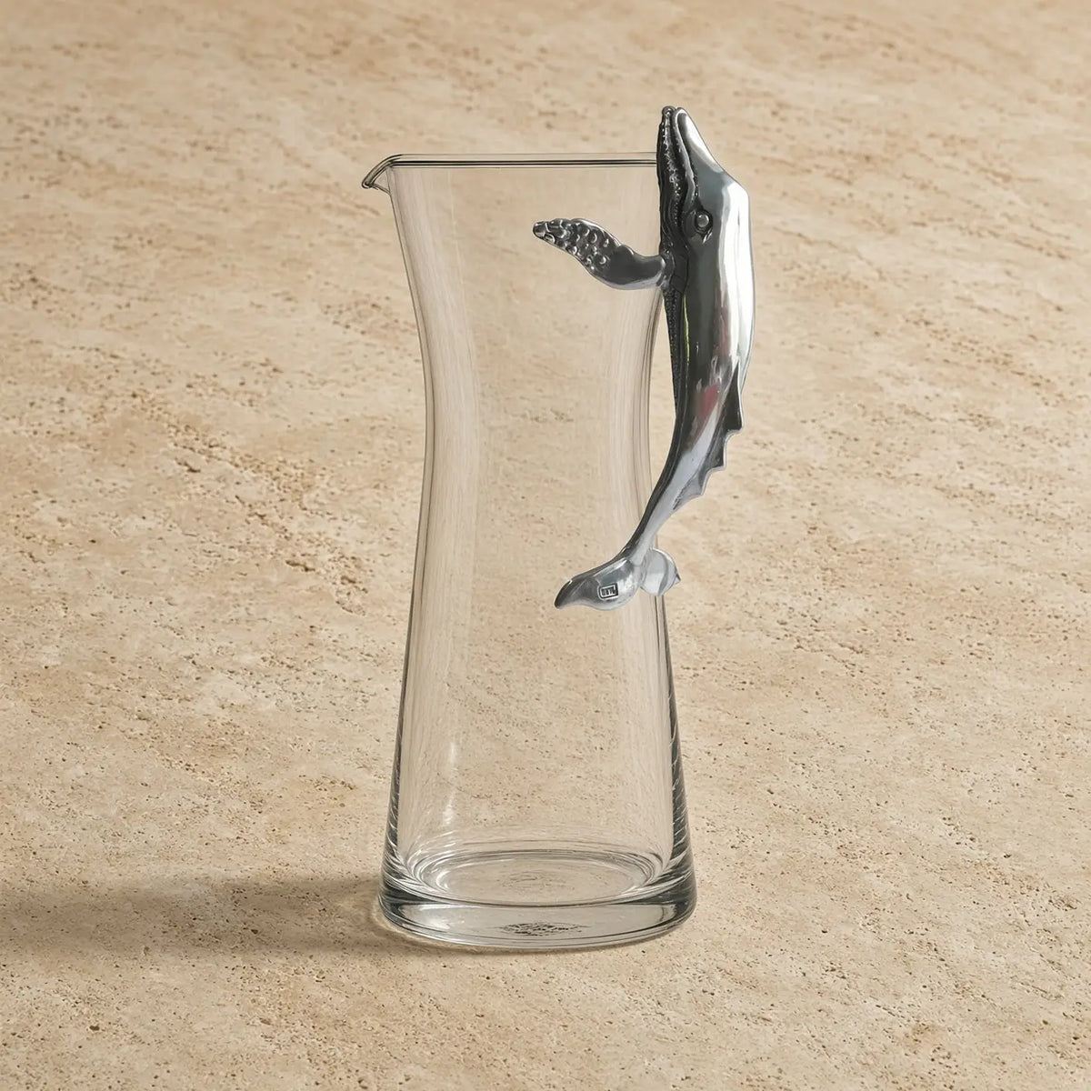 Clear glass carafe with pewter whale handle adds a nautical twist to your drinkware collection