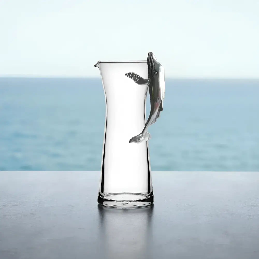 Handcrafted glass carafe with pewter whale handle on ocean view
