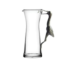 Handcrafted glass pitcher with pewter crane handle for elegant, eco-friendly beverage serving