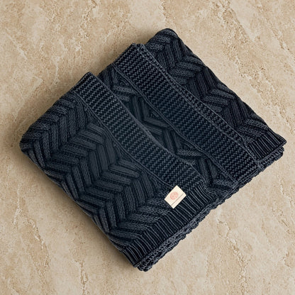 Handcrafted navy blue chevron throw blanket featuring dark gray herringbone knit with tactile luxury and artisanal craftsmanship