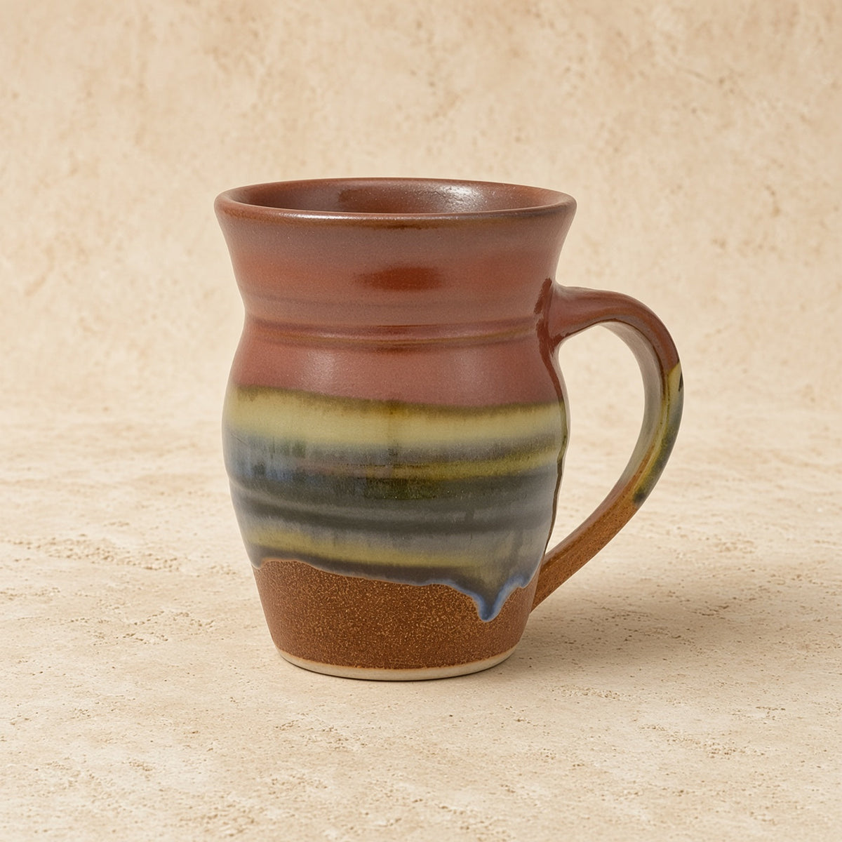 Handcrafted pottery mug aztec sunrise with rustic brown green blue glaze stripes and sunrise vibes drip design