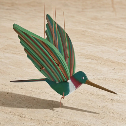 Handcrafted ruby throated hummingbird flying kinetic mobile with vibrant green and pink painted wood sculpture