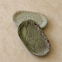 Two beautiful handmade soap dishes in muted green and brown stoneware with a textured reptile-skin pattern for customers bathroom
