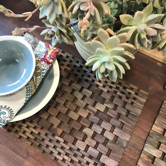 Light blue ceramic bowl on white plate with colorful paisley napkin, rustic pair rosewood placemats set