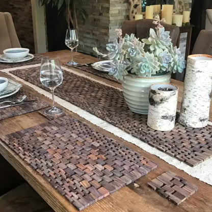 A cozy dining setup with a rosewood table runner and a succulent centerpiece