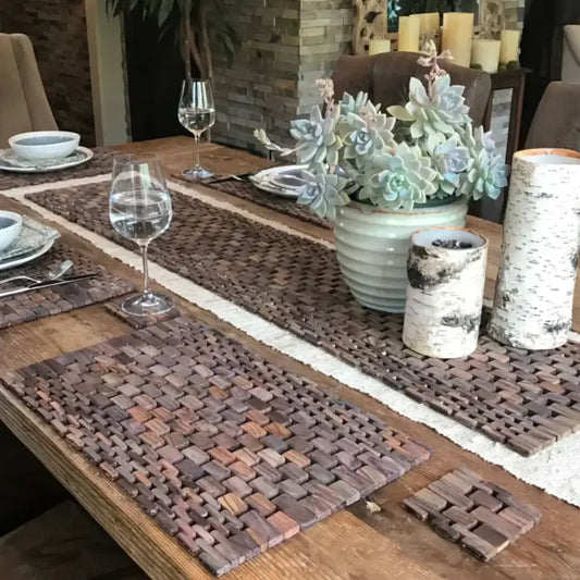 A cozy dining setup with a rosewood table runner and a succulent centerpiece