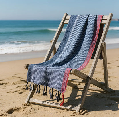 Handloomed turkish cotton bath towel with indigo tribeca handmade blue white and red stripes draped over wooden chair