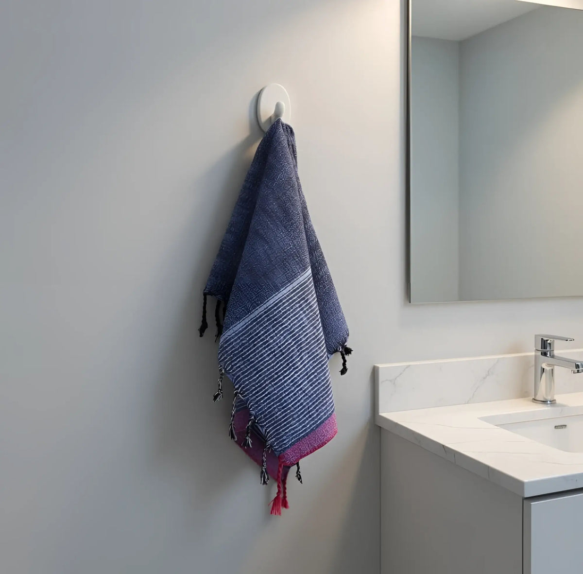 A handloomed turkish cotton bath towel in navy blue and pink stripes with fringed edges by skilled artisans indigo tribeca